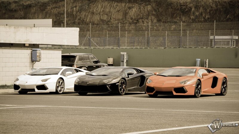 three lamborghini aventadors parked