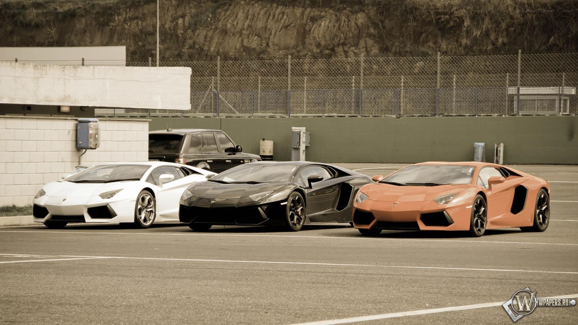 three lamborghini aventadors parked