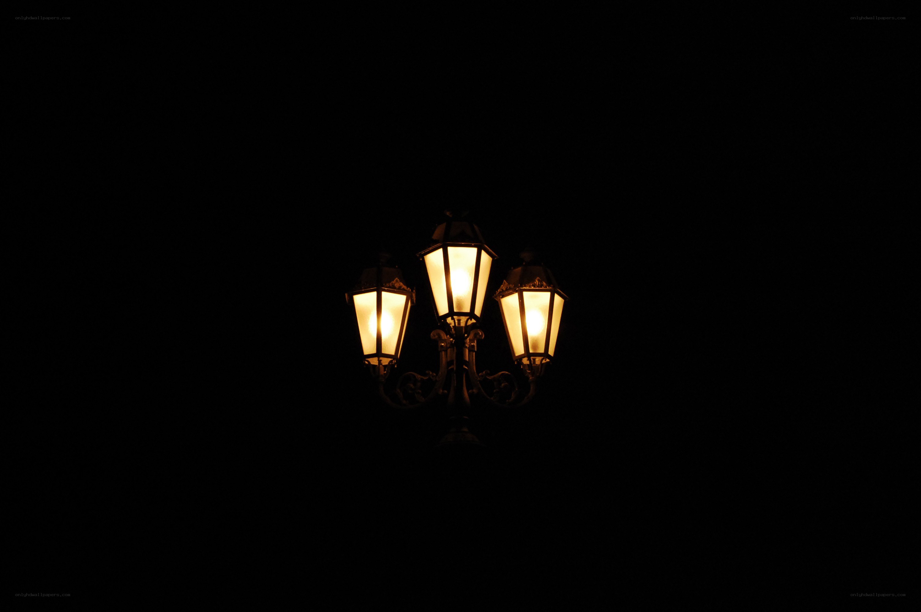 three-lamp streetlight at night
