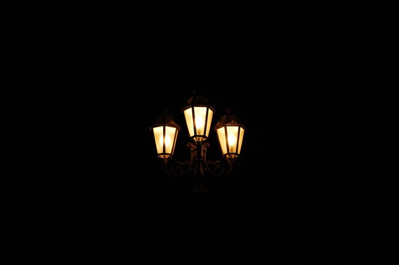 Three-lamp streetlight at night