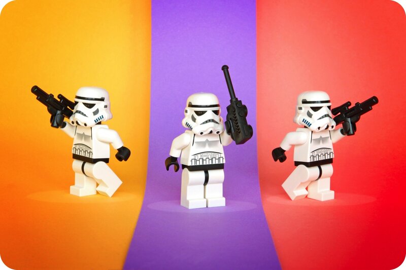 Three LEGO stormtroopers on colorful background