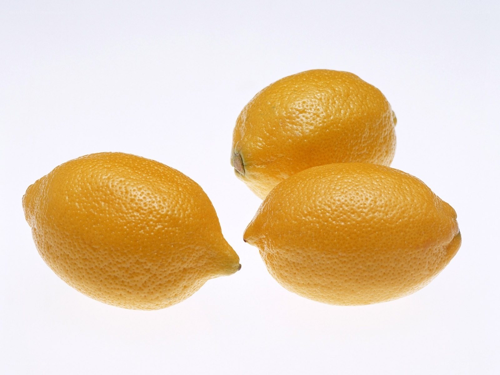 three lemons on white background