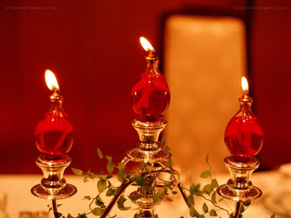 Three lit oil lamps