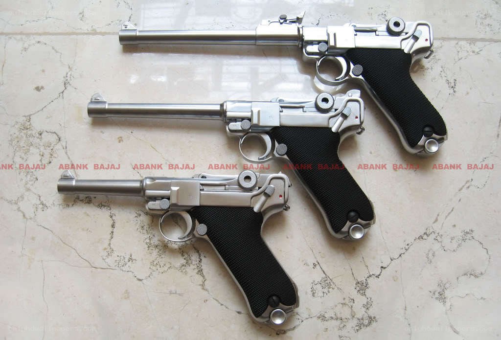 Three Luger pistols on marble