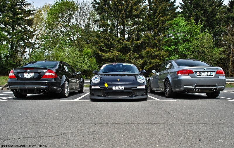 three luxury cars in parking lot