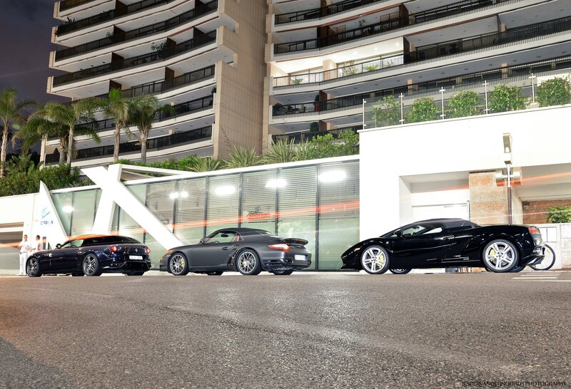 Three luxury sports cars at night