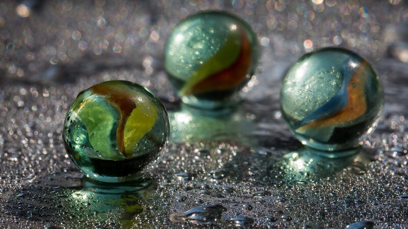 Three Marbles on Wet Surface