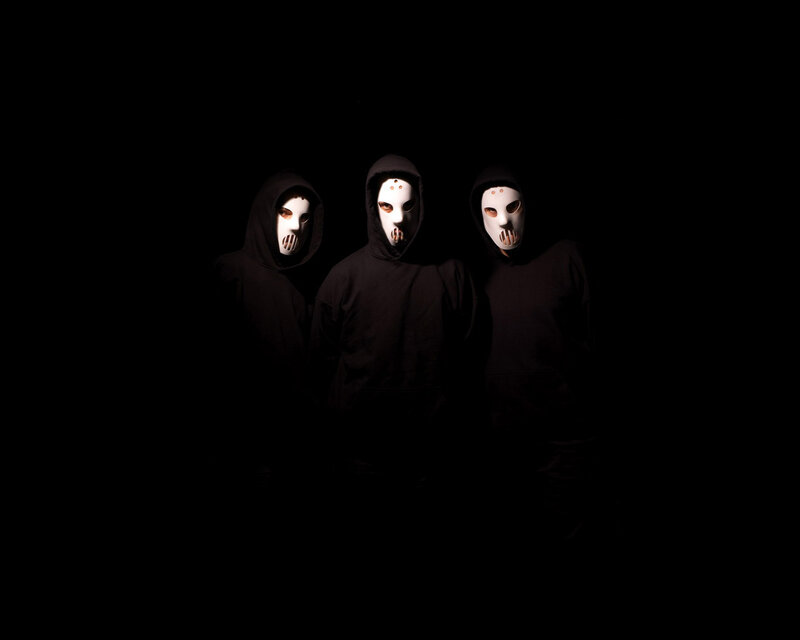 three masked figures in black