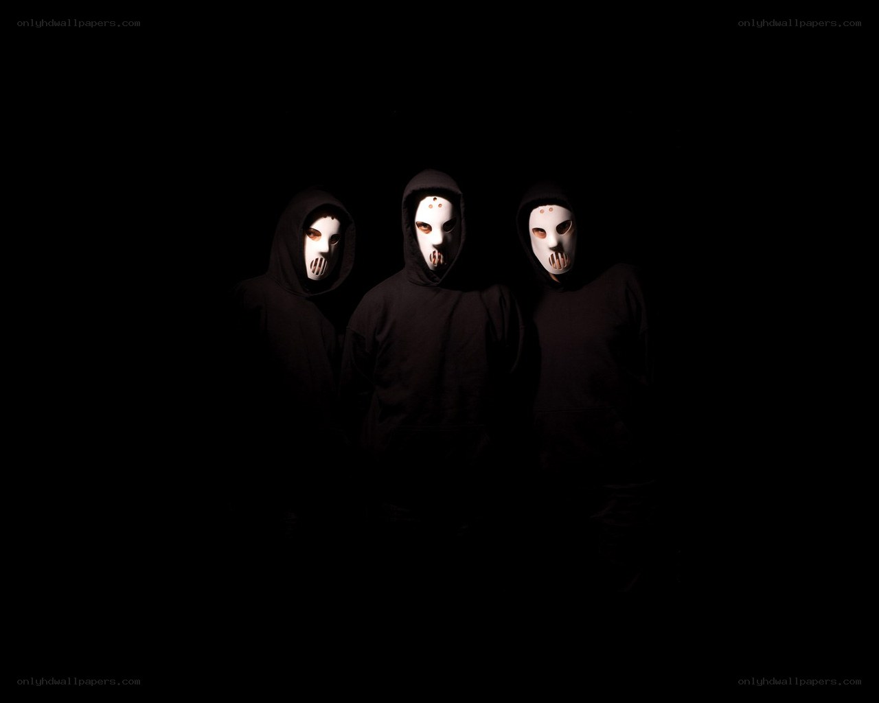 three masked figures in black