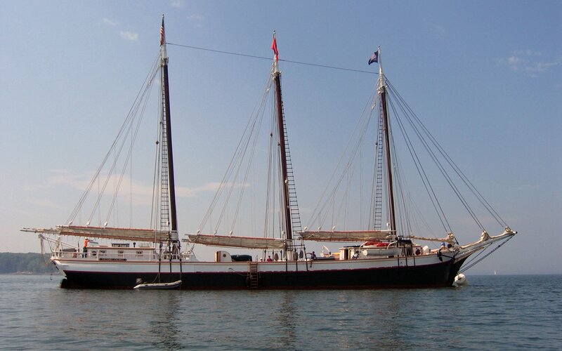 three-masted sailing ship on calm water