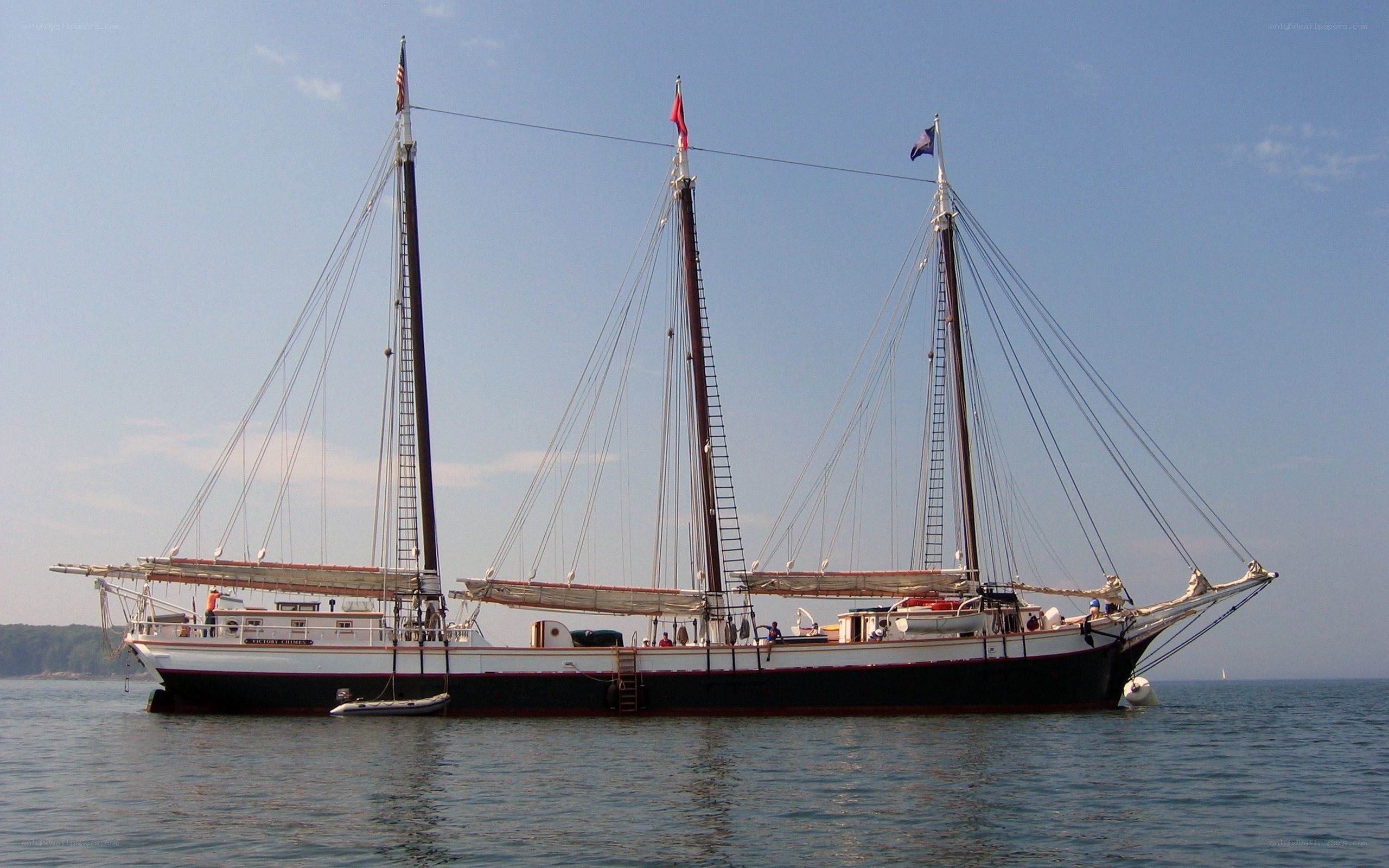 three-masted sailing ship on calm water