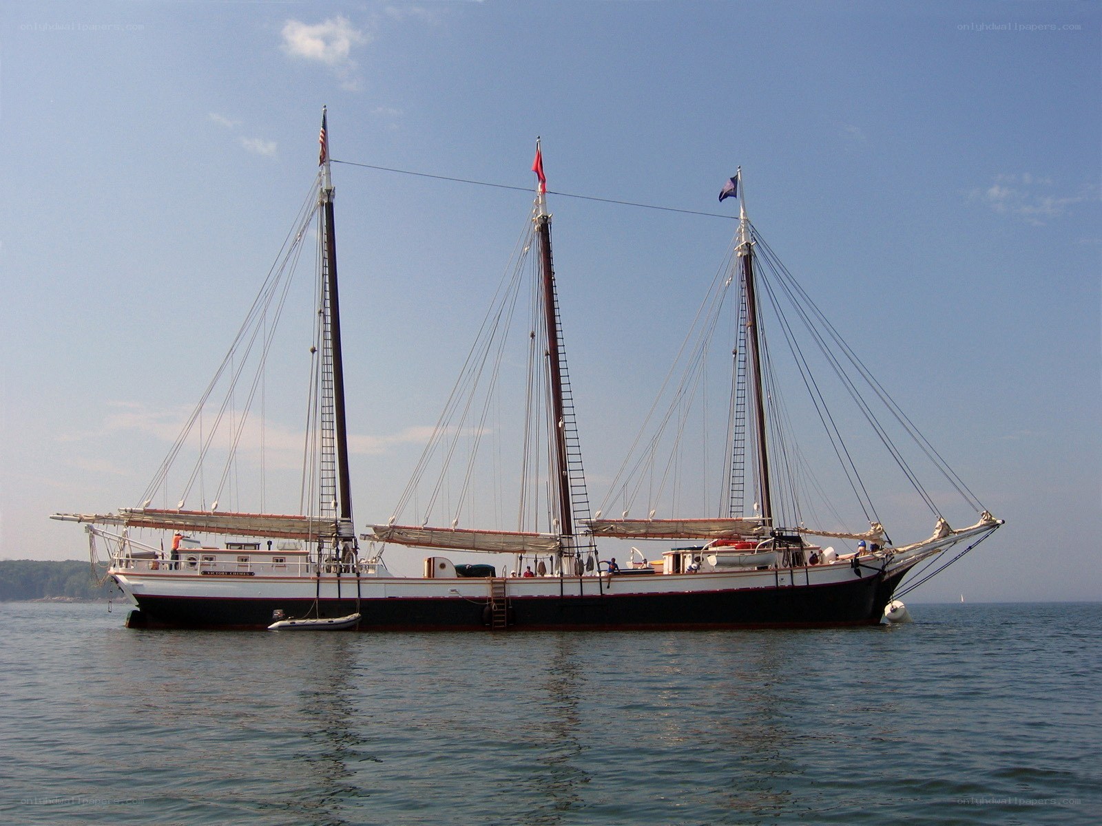 Three-masted sailing ship on calm water