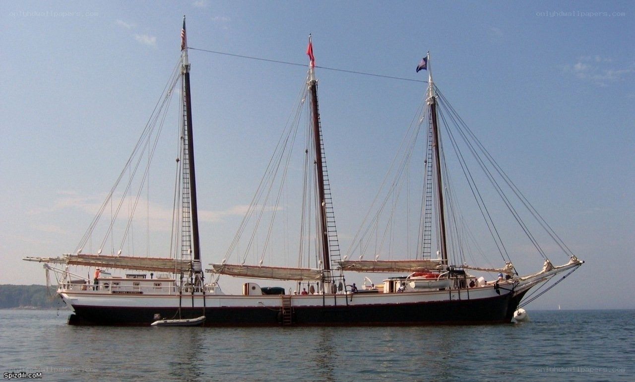 three-masted schooner on calm water