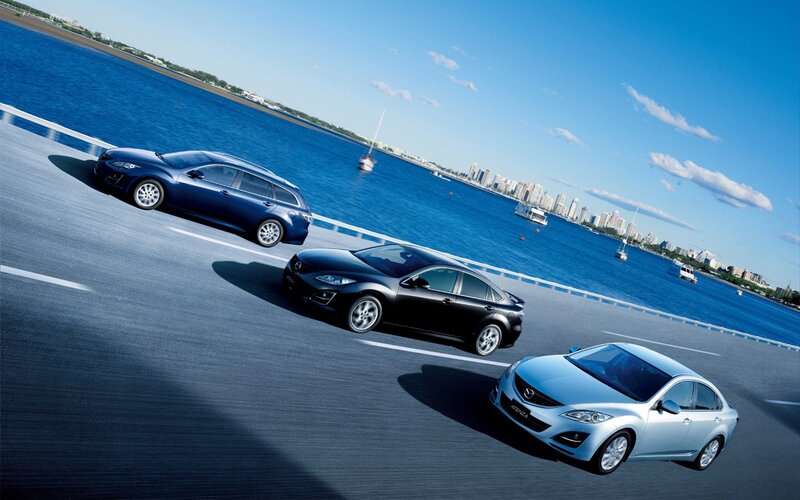 Three Mazda Cars on Road