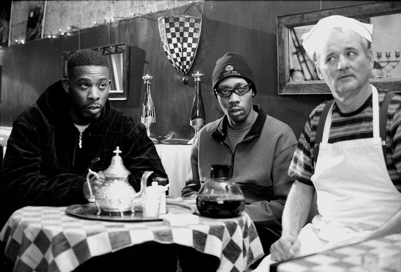 Three men at a cafe table