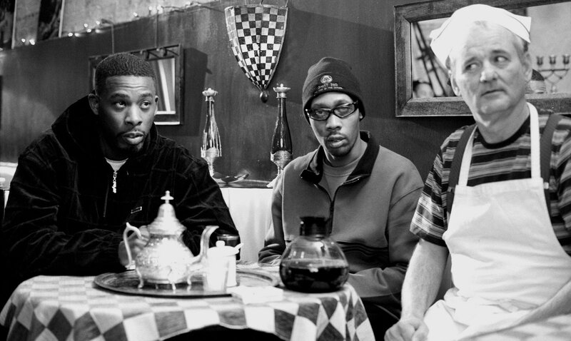 Three men at a cafe table