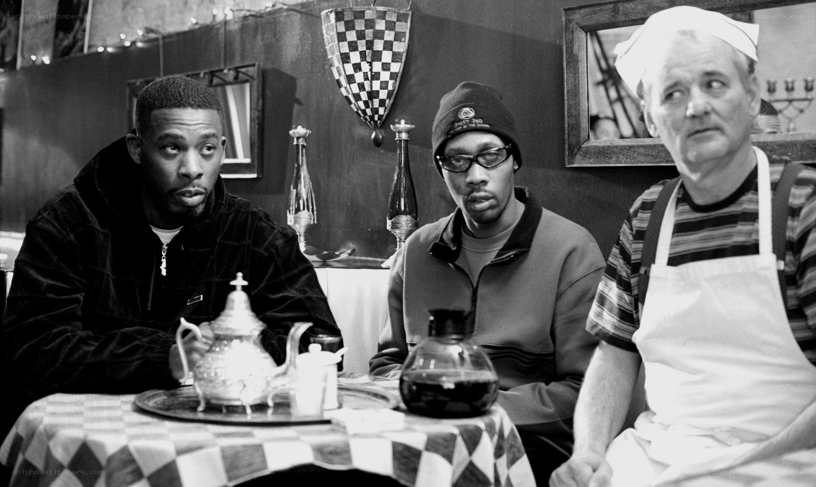 Three men at a cafe table