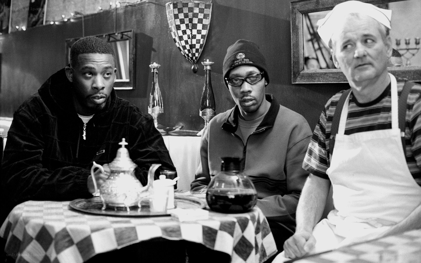 Three men at a cafe table