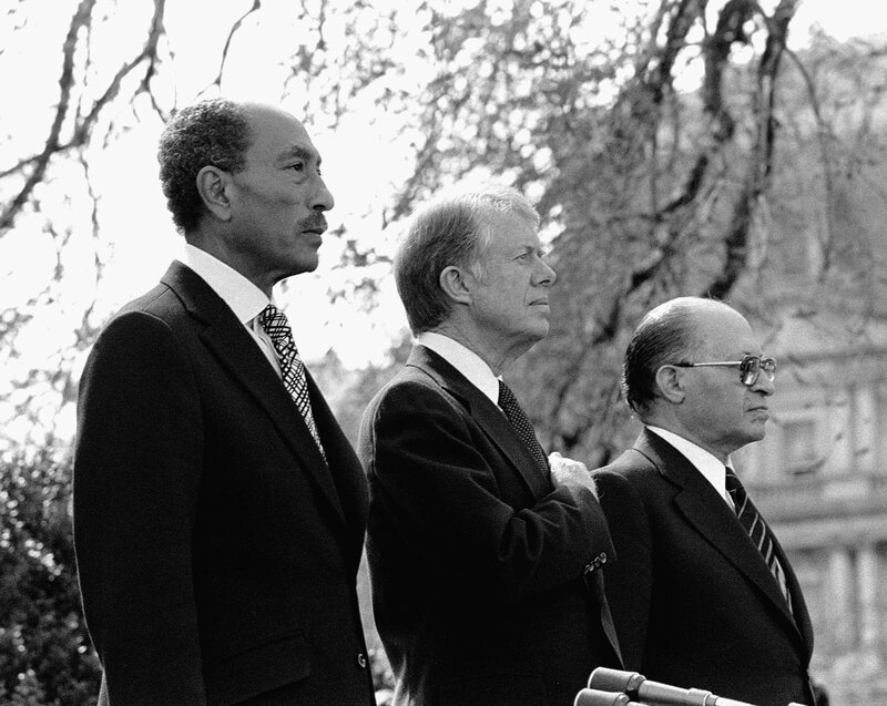 three men at a podium