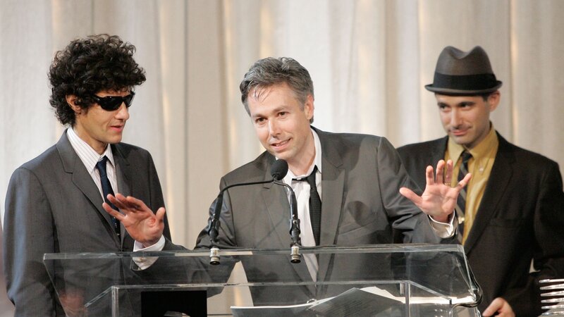 Three men at a podium