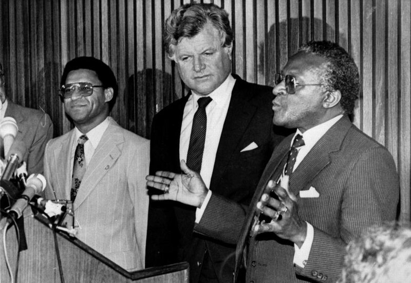 three men at a press conference
