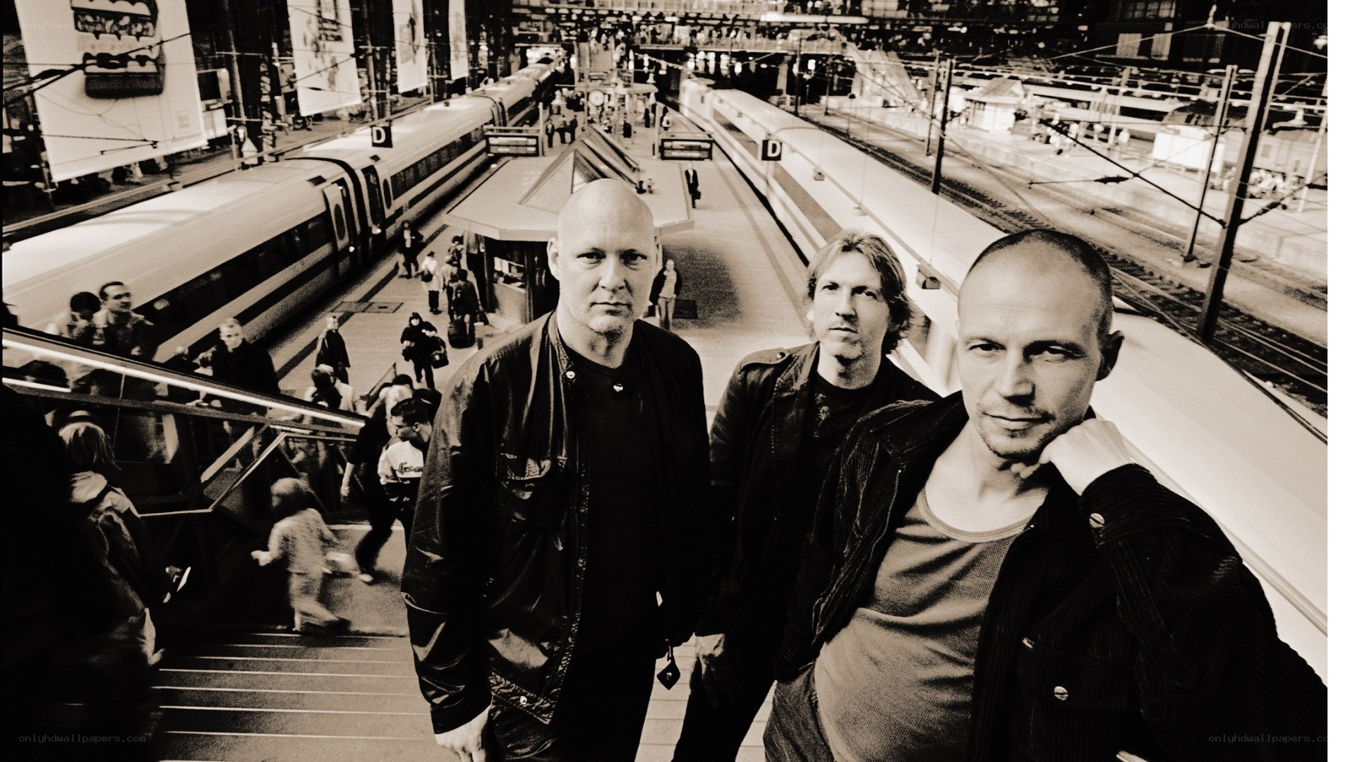 Three men at a train station