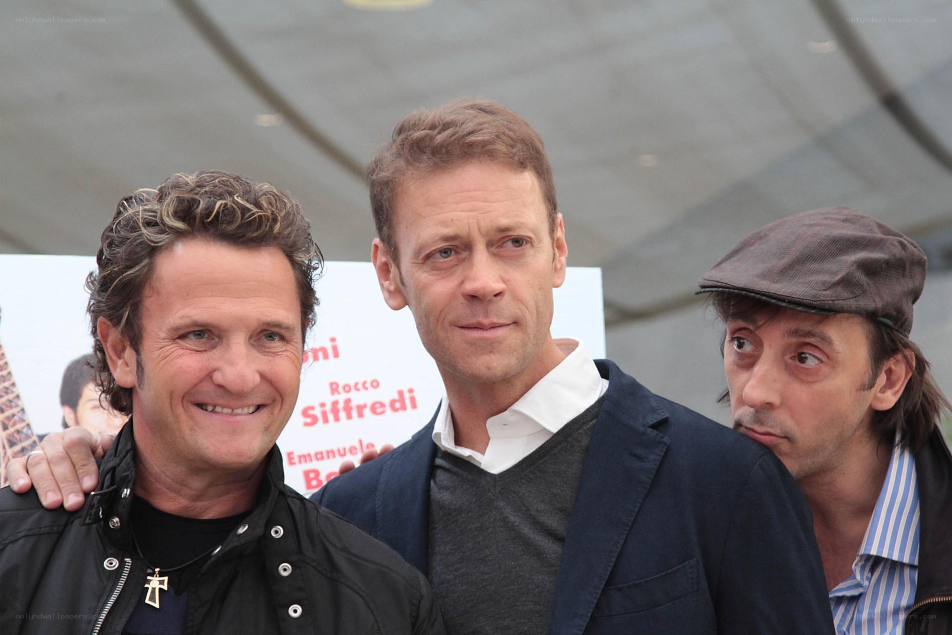 three men at public event