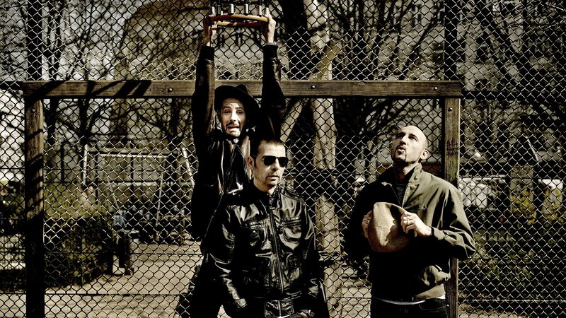 Three Men Behind Fence