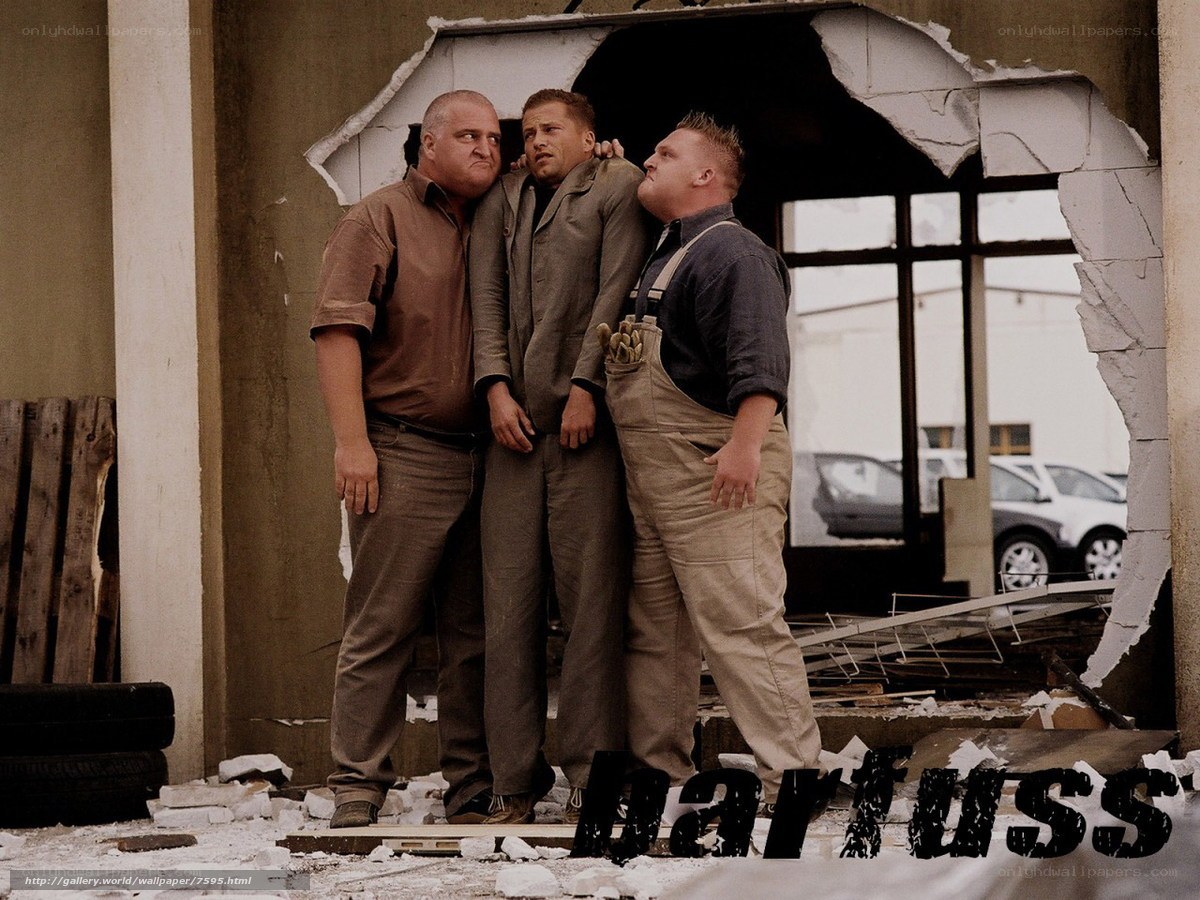 Three men in a damaged building