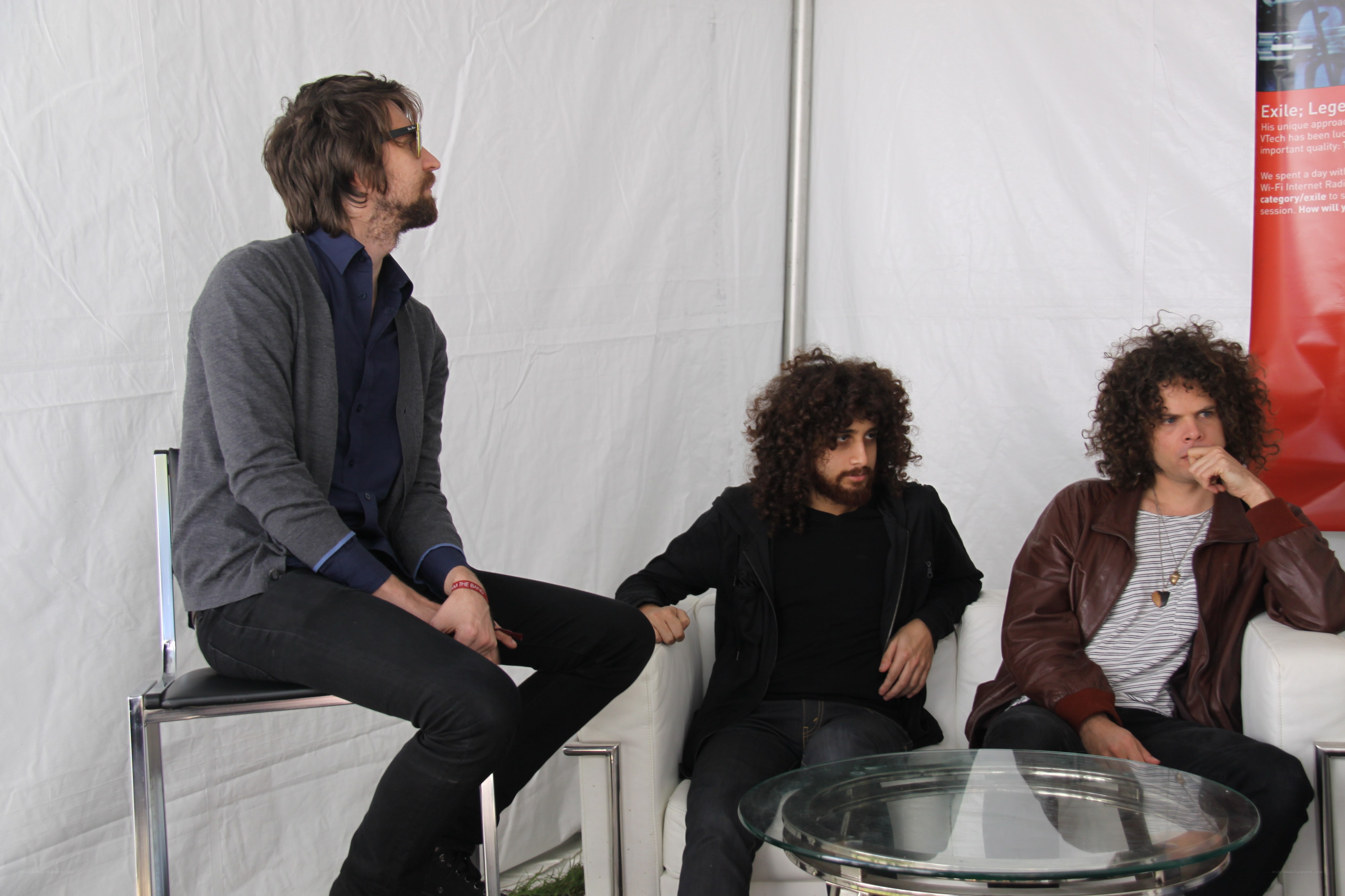 three men in a discussion