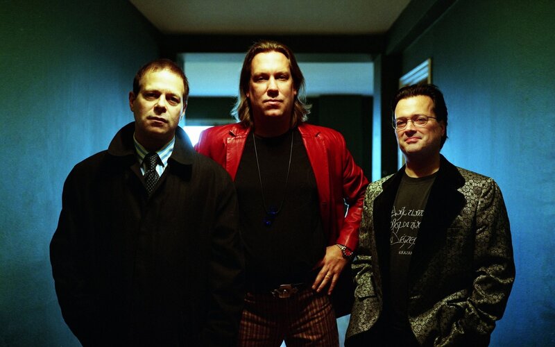 three men in a hallway