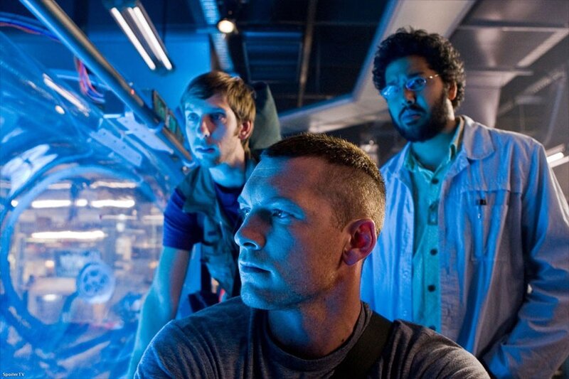 three men in a high-tech room