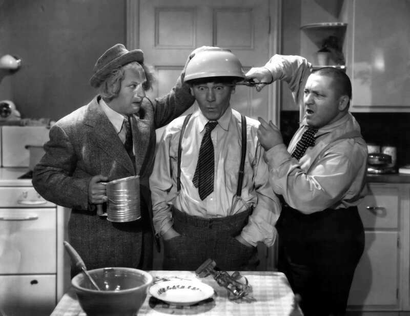 Three men in a kitchen scene