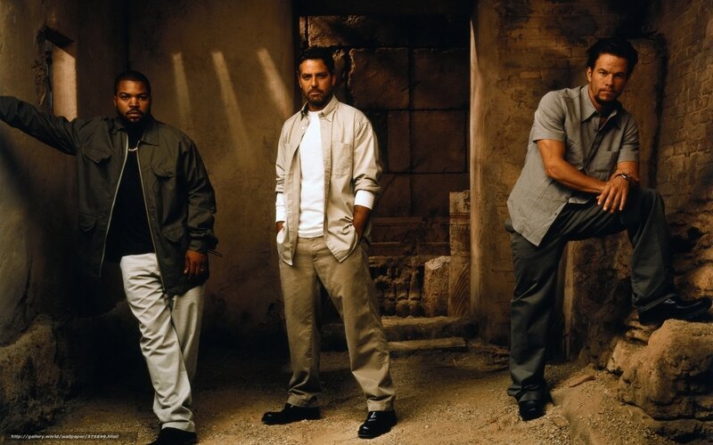 Three men in a stone corridor