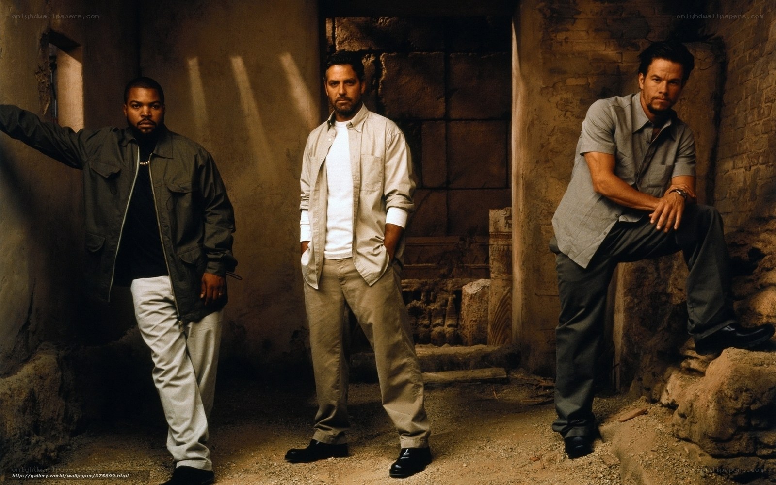 Three men in a stone corridor