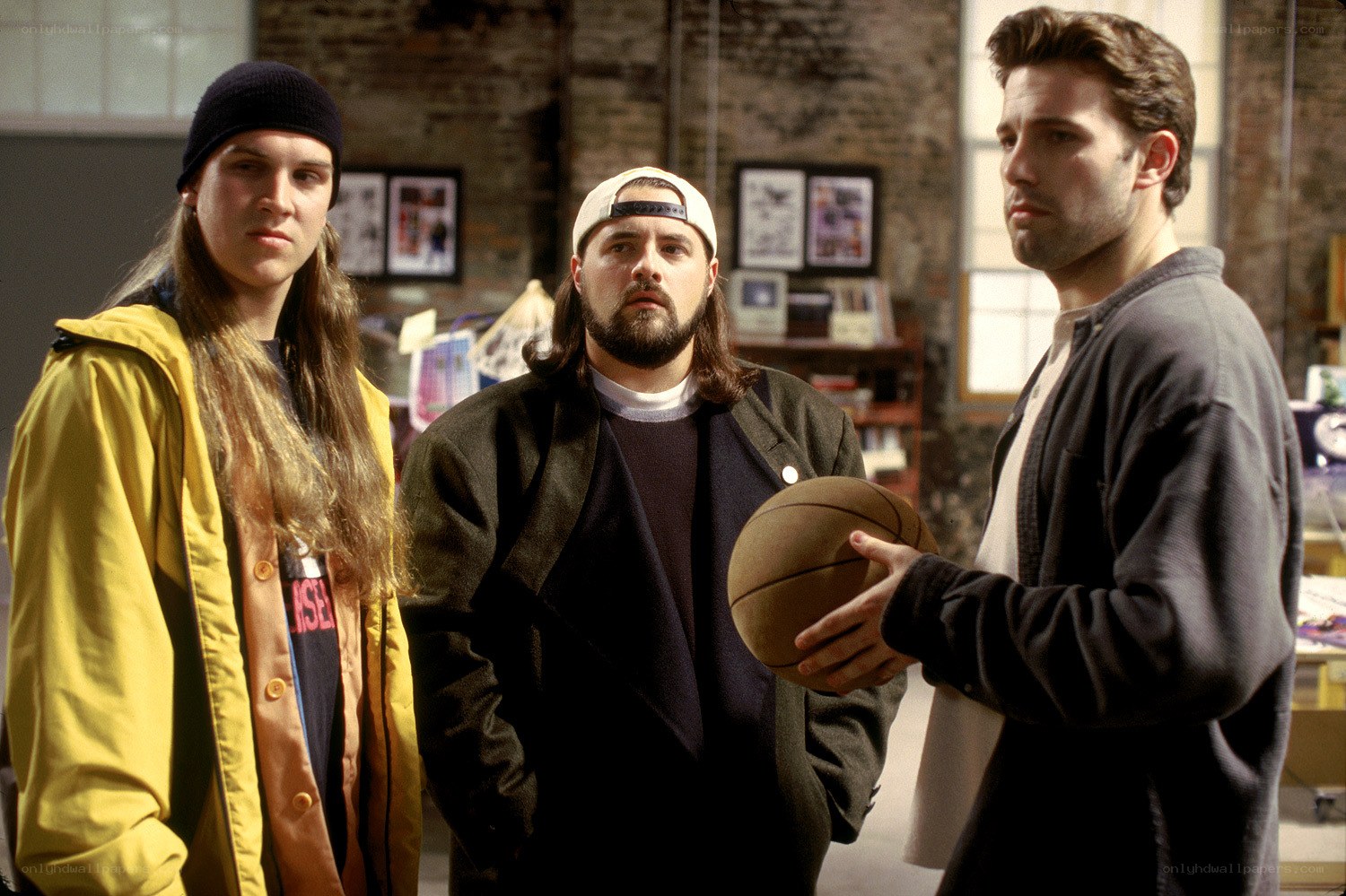 Three men in a warehouse with basketball