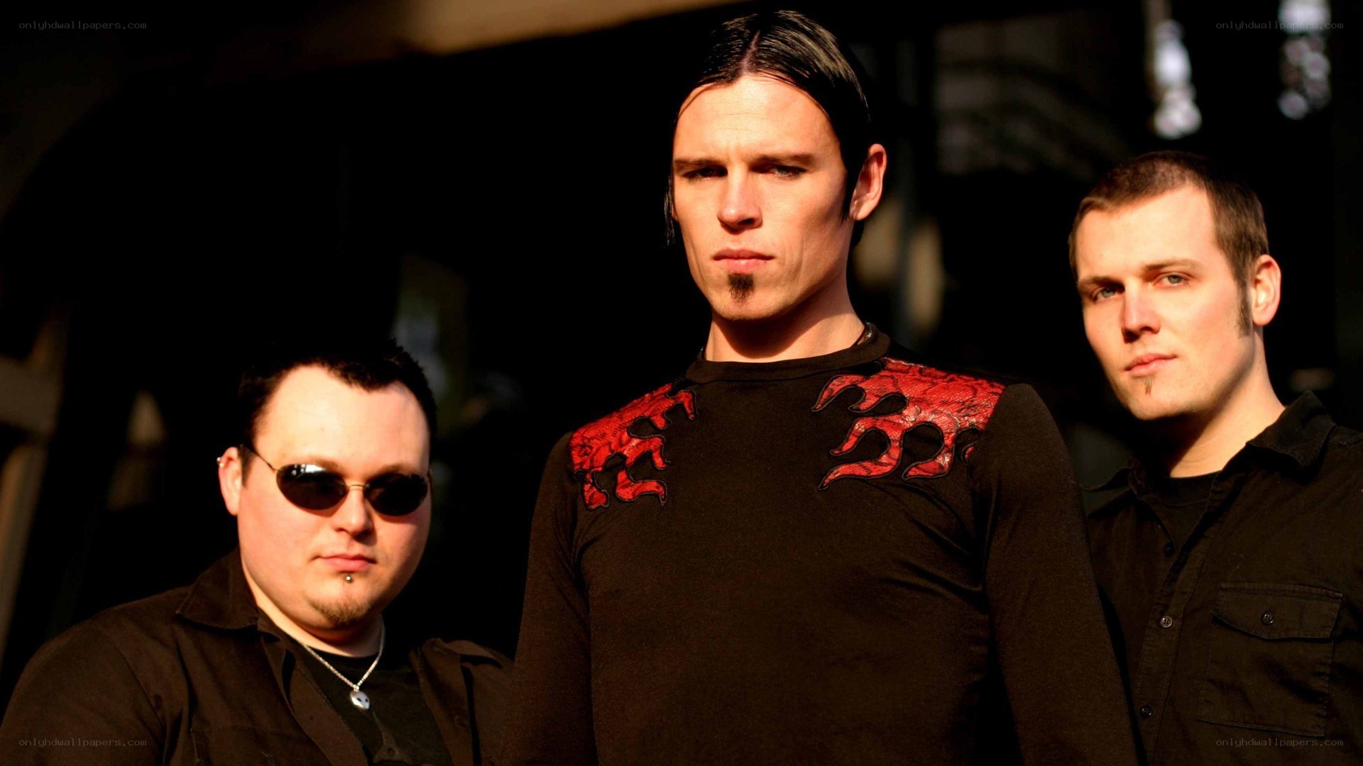 three men in black clothing