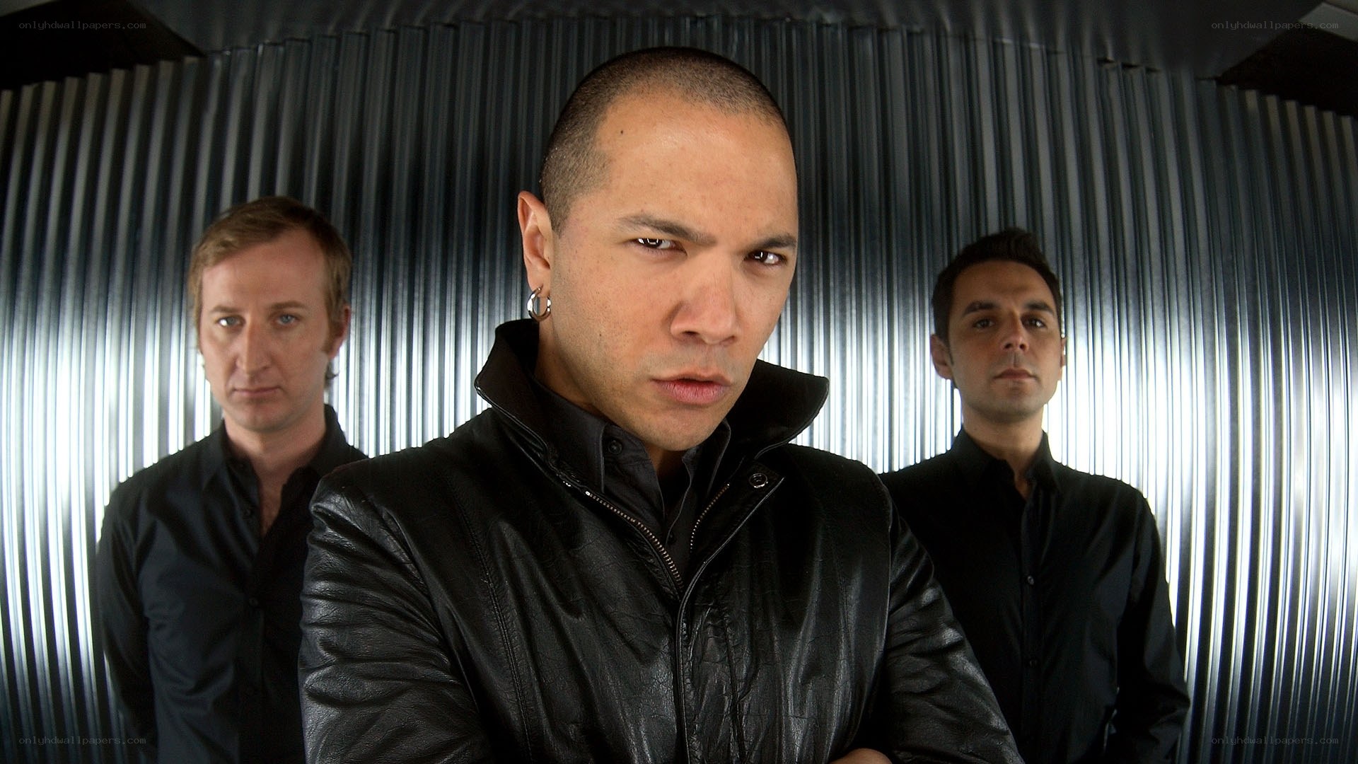 three men in black clothing