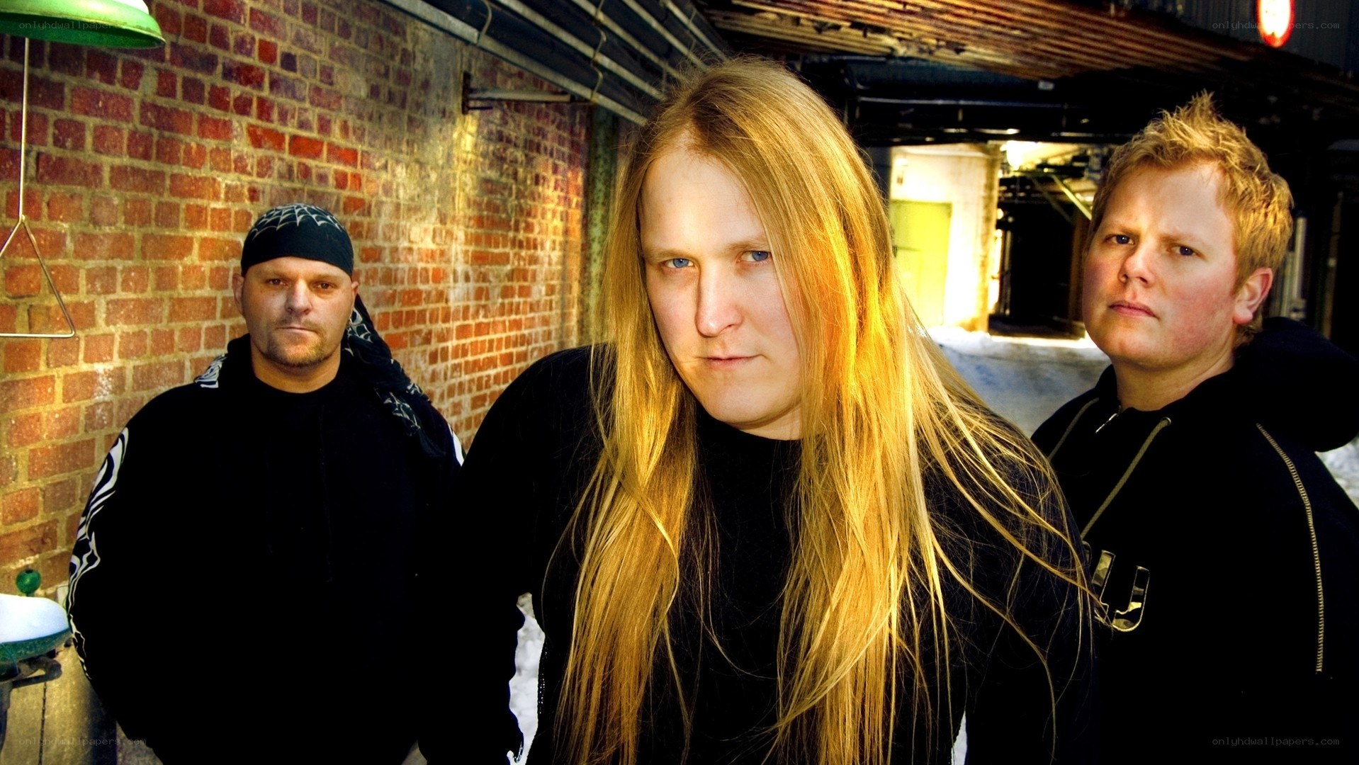 three men in black hoodies