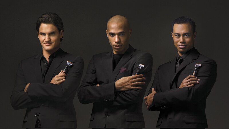 Three men in black suits with razors