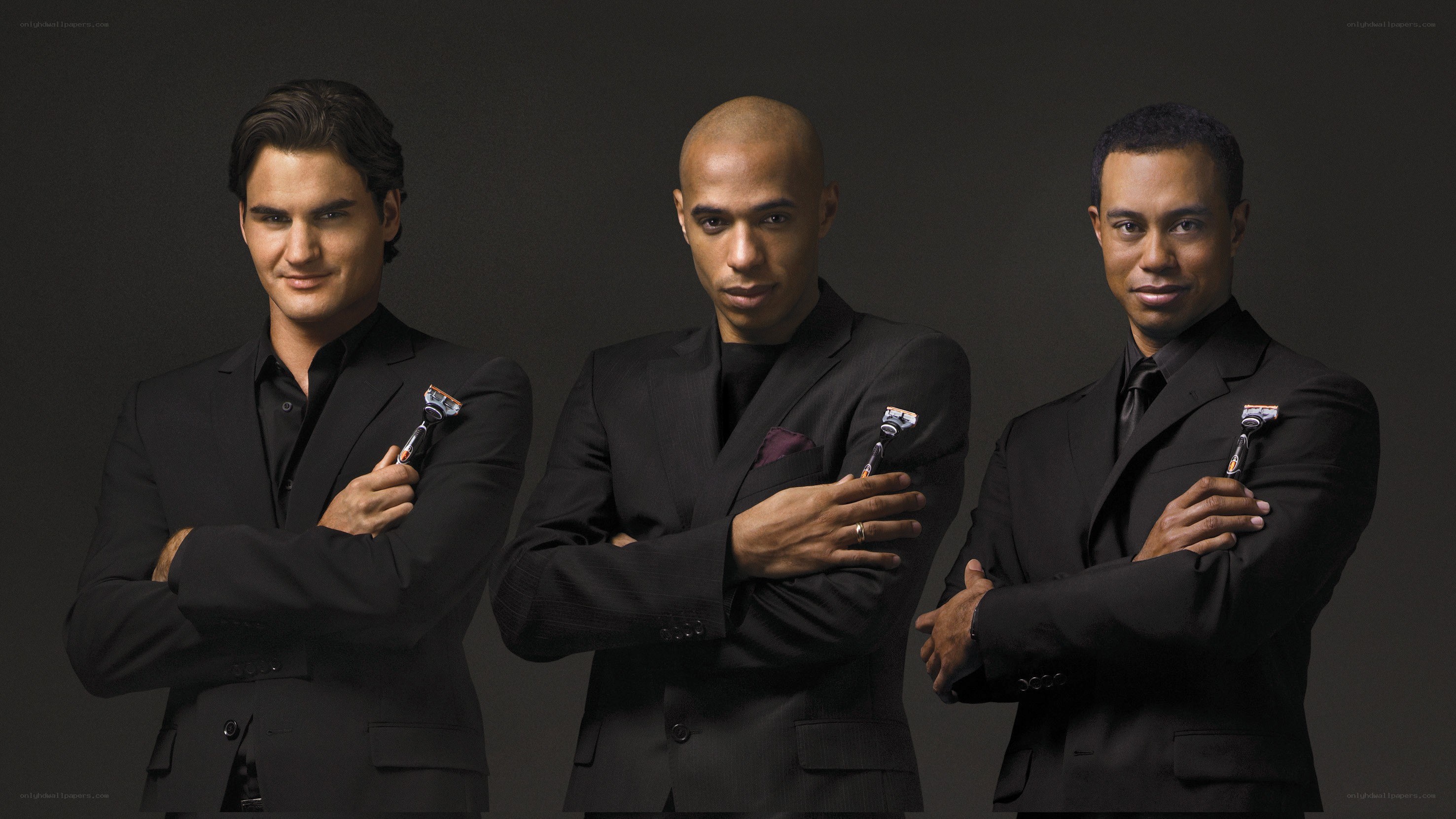 Three men in black suits with razors