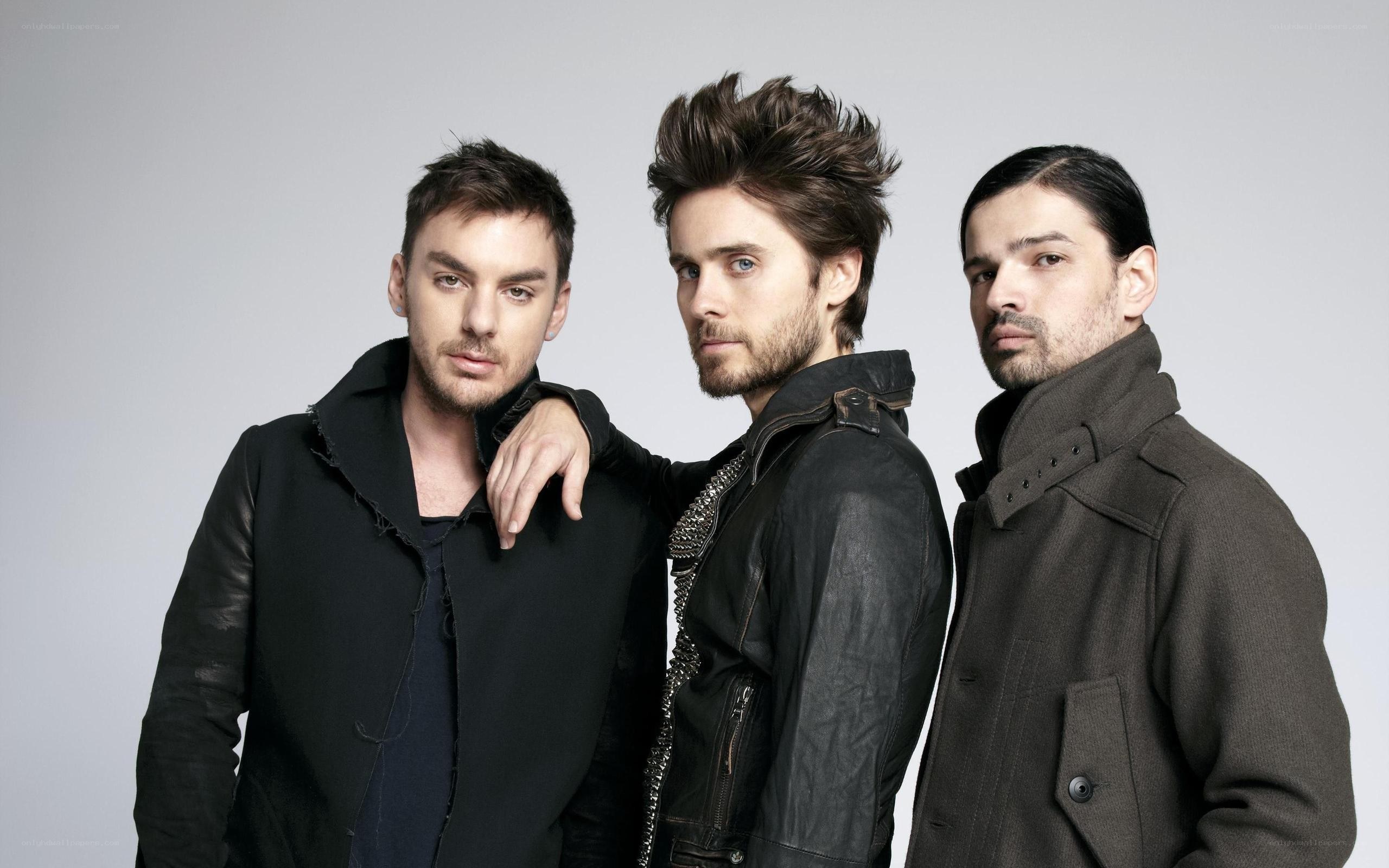 three men in dark clothing