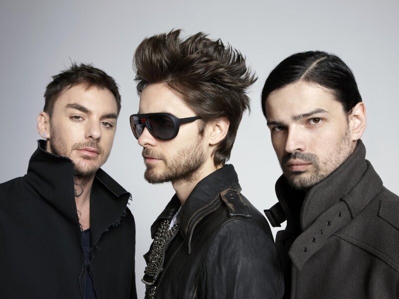 three men in dark clothing