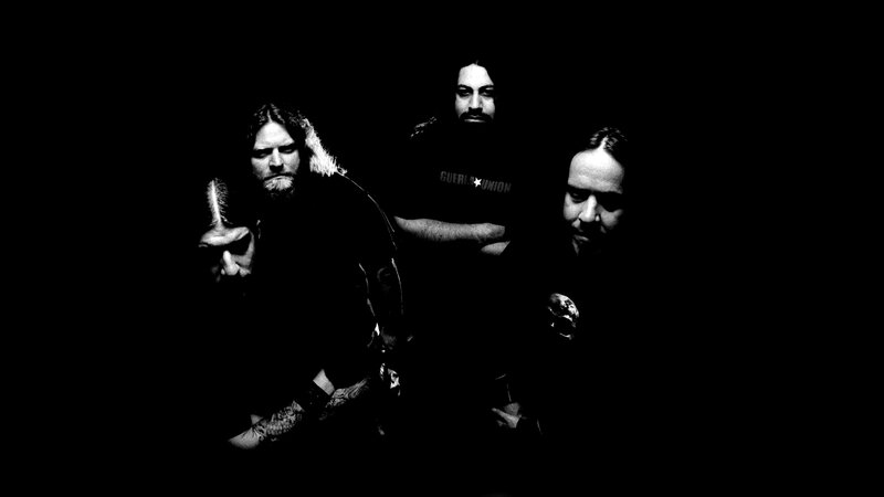 Three Men in Dark Room