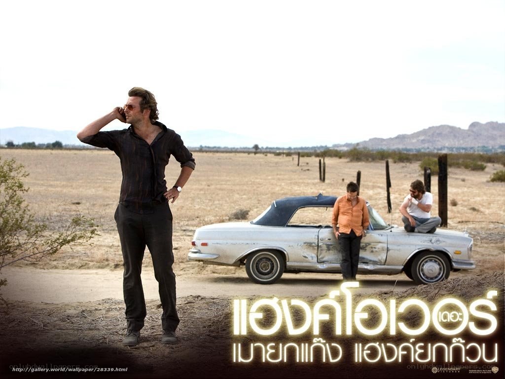 Three men in desert with car