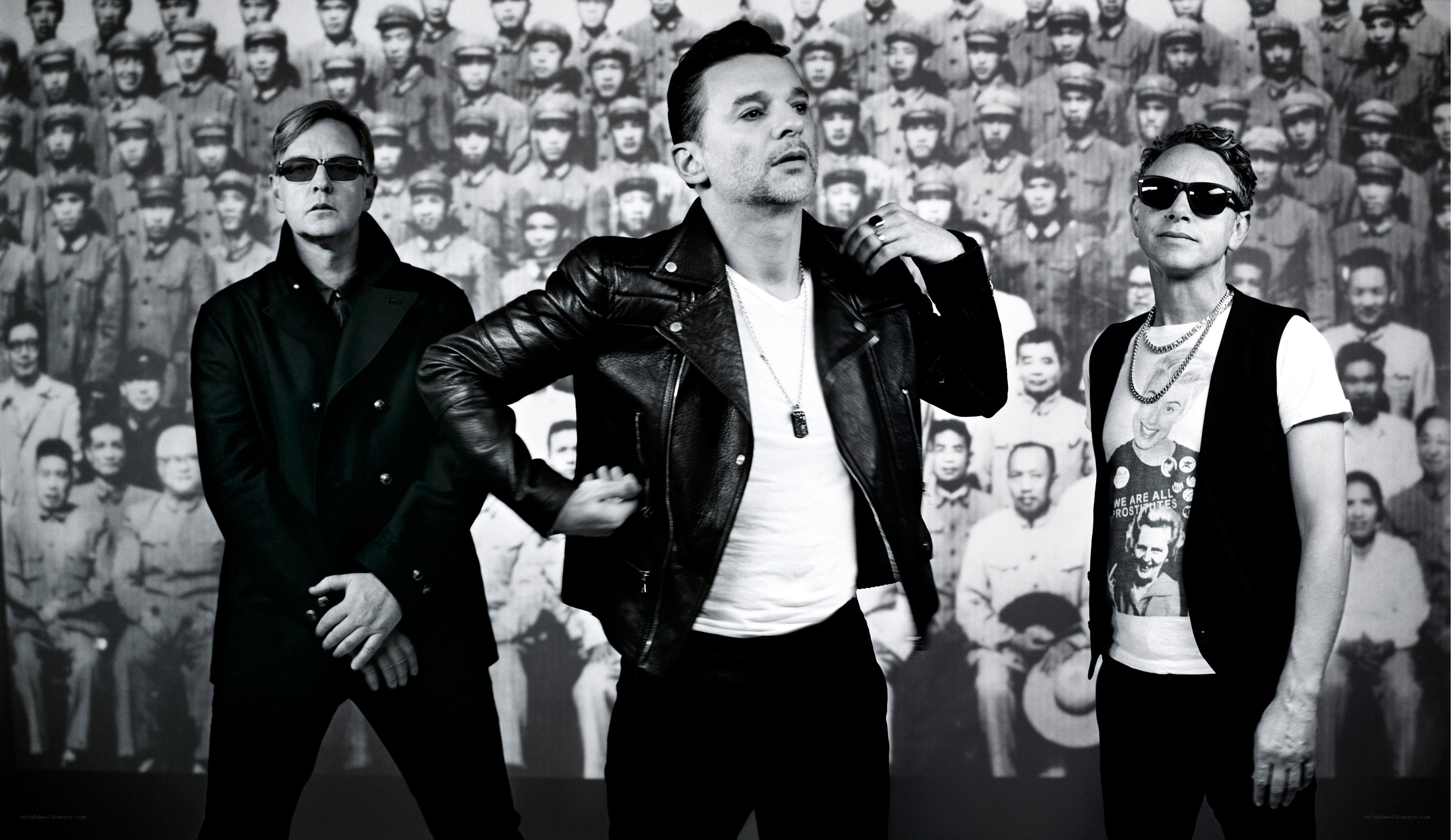 three men in front of a crowd photo
