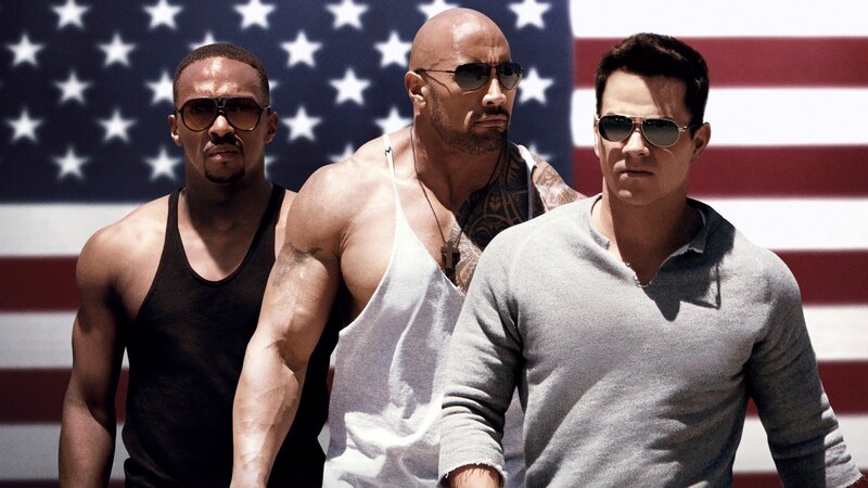 Three men in front of American flag