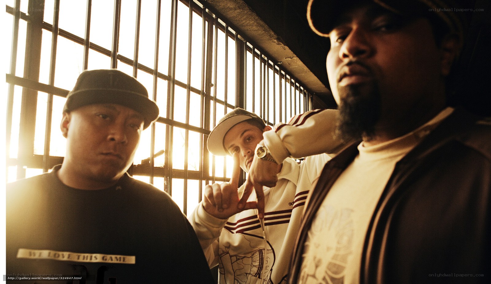 Three men in front of prison bars