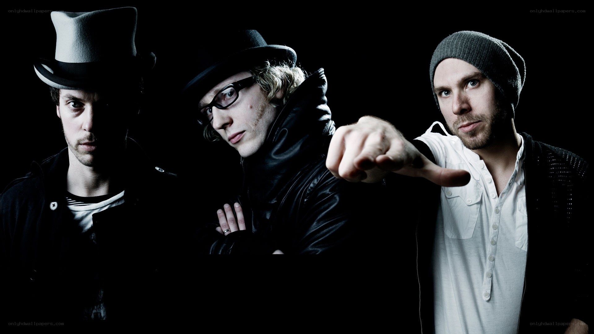 three men in hats and dark clothing