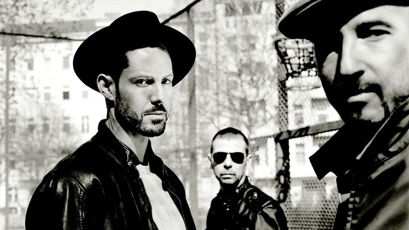 three men in hats and leather jackets
